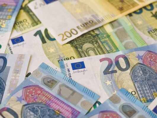 20 euro bill on white and blue textile