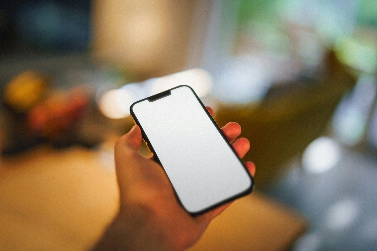 A person holding a cell phone in their hand